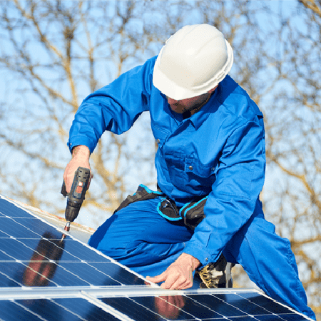 workman installing solar panels on roof.